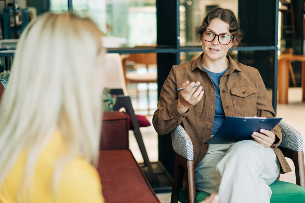 A female psychologist advises a client. Portrait of a professional modern woman. HR hires and conducts interviews.